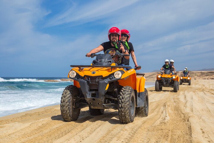 ATV riders on a beach